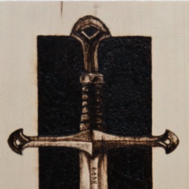 Decorative sword sheath with intricate design on a beige background